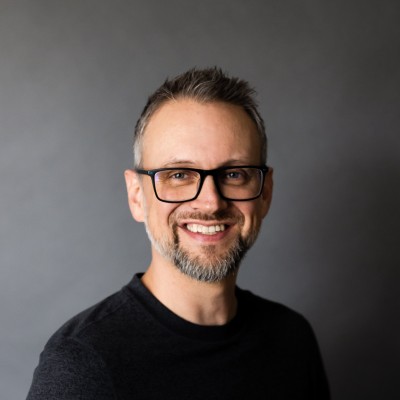 Jarod Ferguson smiling, wearing a black shirt and glasses